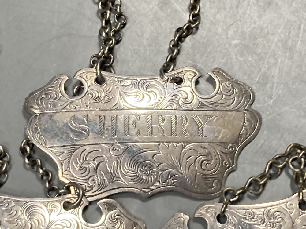 A matched set of three Victorian engraved provincial silver wine labels by William Rawlings Sobey,